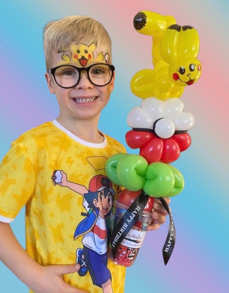 Boy holding balloon animals