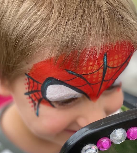 Spider-Man face paint on a young boy